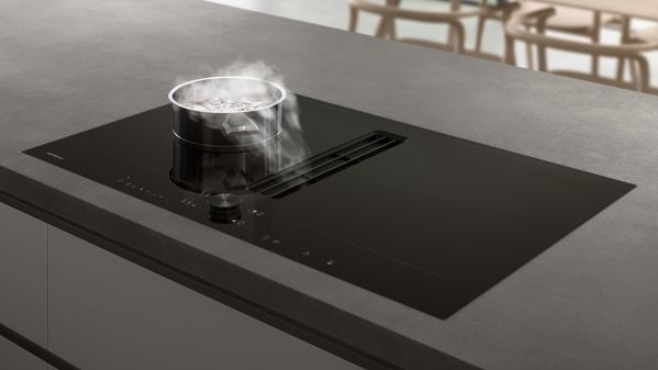 Table de cuisson flex induction Gaggenau série 200 avec aérateur de plan de cuisson intégré, en action