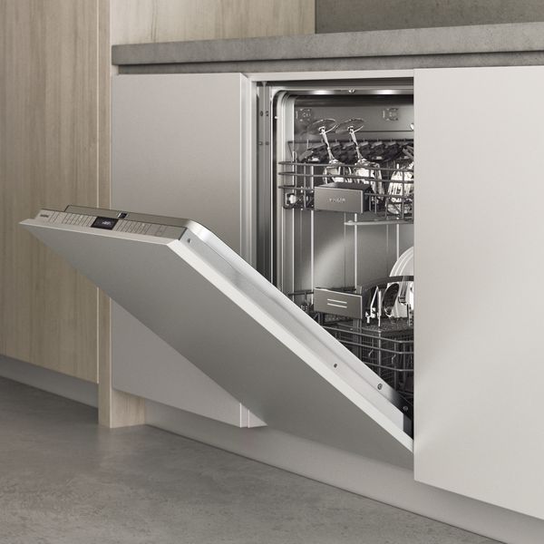 A Gaggenau 200 series dishwasher in a modern environment with its door open 