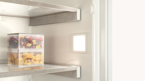 Interior of Gaggenau refrigerator with warm hue from the lighting