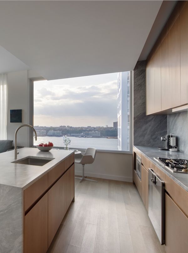 A kitchen in a luxury New York apartment, with Gaggenau appliances, overlooking the harbour 