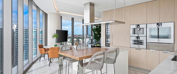 Image of a bright kitchen and dining area in a Ritz Carlton Residence at Sunny Isles Beach 