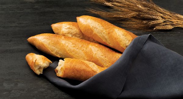 An image of French baguettes and head of wheat