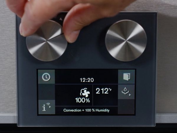 An image showing a hand turning the knob on a Gaggenau oven