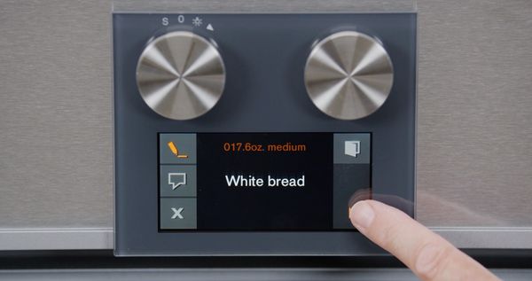 An image of a finger selecting the white bread mode on a Gaggenau oven