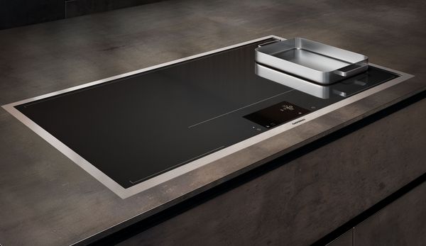 Image of a Gaggenau full surface induction cooktop featuring a stainless steel pan.
