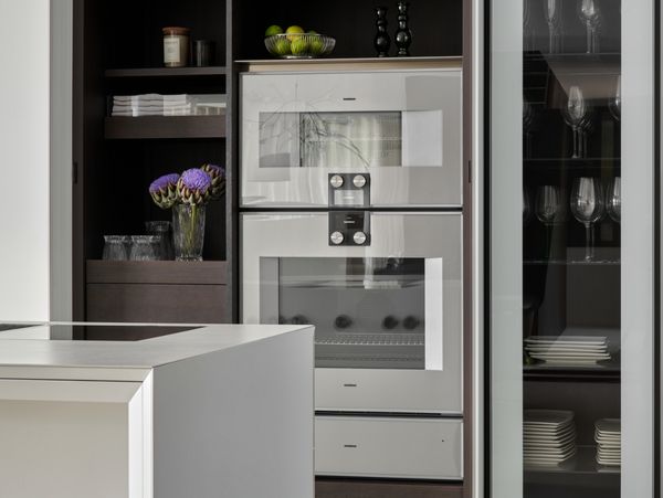 Modern luxury kitchen containing a Gaggenau combo-steam oven and Gaggenau convection oven