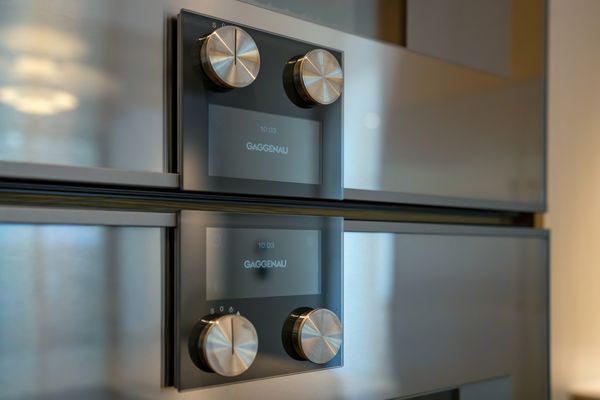 Close-up of the iconic Gaggenau oven control knobs.