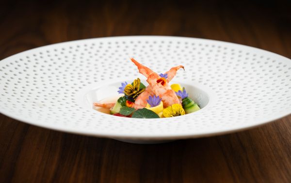 Spot prawns, makrut, lime-infused tomato water and mango arranged on a Hering Berlin dish.