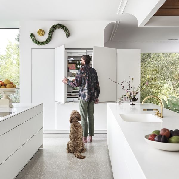 Chet and dog Lewie enjoy convenient access with a built-in Gaggenau refrigerator-freezer. Photography by Jon Day.