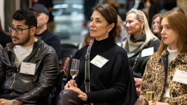 Paulina Perrault of Paulina Perralt Interiors listens intently to Newell Turner's presentation.
