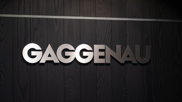 The Gaggenau logo set against the wall in impeccable stainless steel.