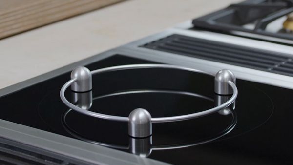 Close-up of a Gaggenau 400 series Vario induction cooktop and wok ring accessory