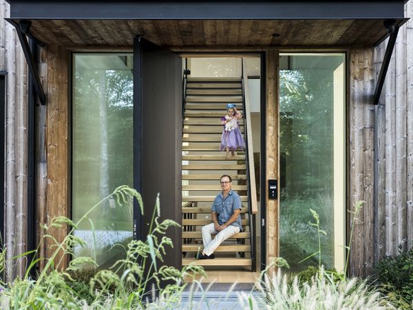 The entryway to Sam Fertik's home, where he and his daughter pose on the stairway.