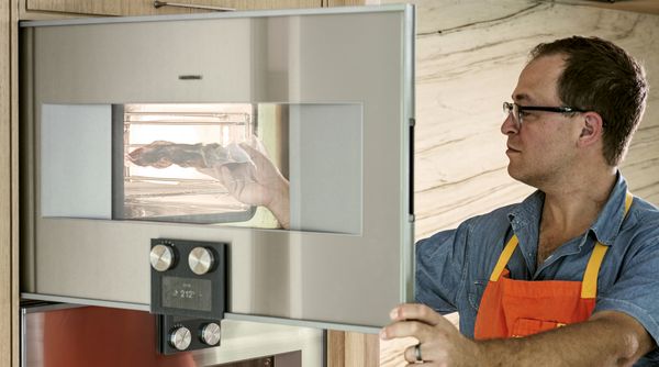 Sam Fertik using his Gaggenau combi-steam oven.