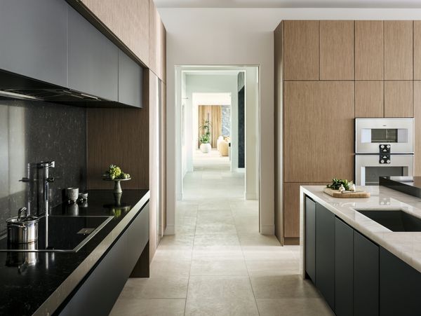 A view of the open hallway area, leading from the kitchen to the other end of the sprawling home.