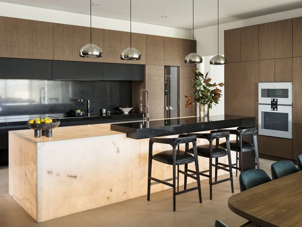 The kitchen space, lit by a glowing Cristallo quartzite island.