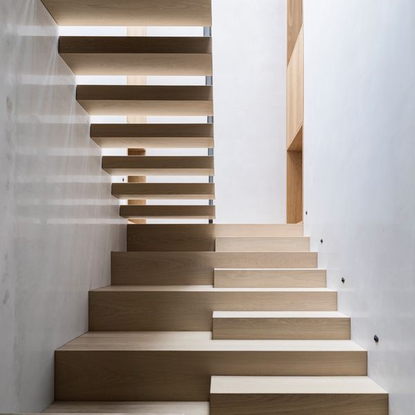 The bright and airy central stairwell featuring floating treads