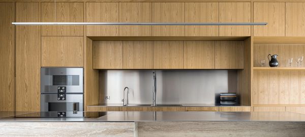 View looking across the kitchen island into a bright, contemporary space fitted with Gaggenau appliances.
