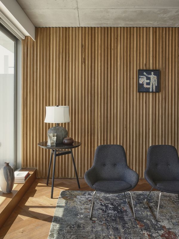 Lounge area of an apartment in 131 Smith Street showing a textural material palette
