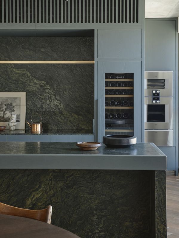 Kitchen area in apartment featuring Gaggenau appliances, natural timber, refined marble, and bespoke joinery.