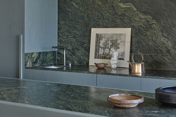Kitchen area in apartment featuring Gaggenau appliances, natural timber, refined marble, and bespoke joinery.