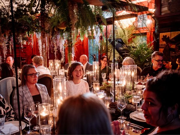 Guests seated at the table for dinner, smiling and laughing.
