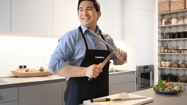 Tohru Nakamura sharpening his knives in his kitchen 