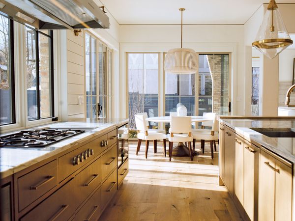 Wide image of elegant kitchen featuring Gaggenau appliances