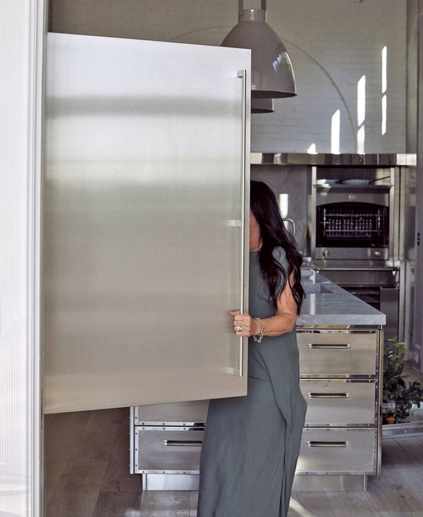 Windsor Smith looking inside her large Gaggenau refrigerator