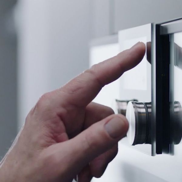 Finger pressing Gaggenau 400 series oven interactive display 