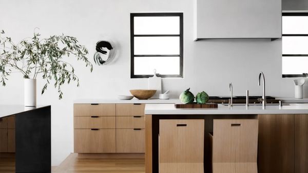 A sleek, modern kitchen with tasteful wood cabinets. 