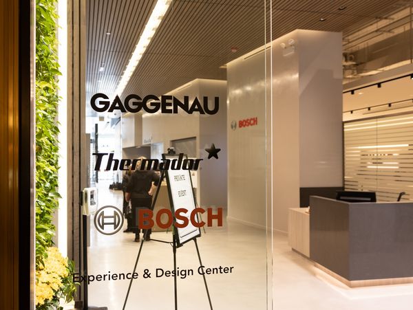 The glass façade outside of the Gaggenau showroom, depicting logos for Gaggenau, Thermador, and Bosch. 