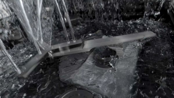 The image taken inside of a dishwasher while spraying water 