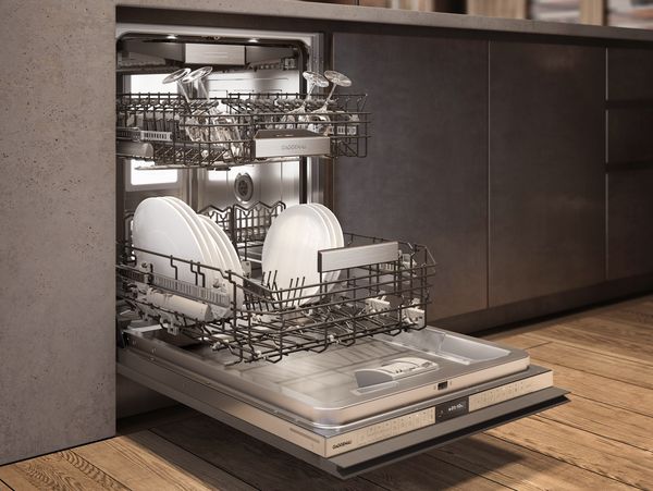 A Gaggenau 400 series dishwasher in a modern environment with its door open 
