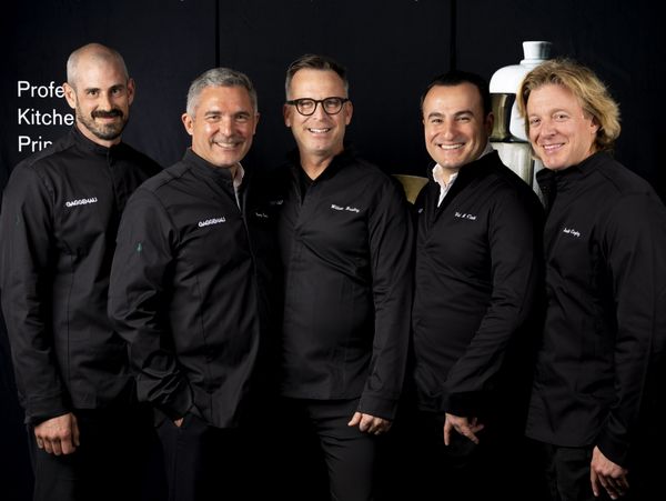 The chefs honored posing in front of a dark background. 