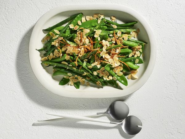 Bean and snow pea salad with preserved orange and almonds in a bowl