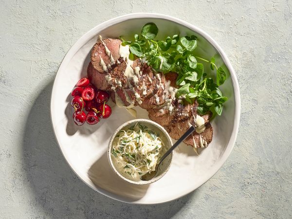 Rare roast beef fillet with remoulade on a serving plate