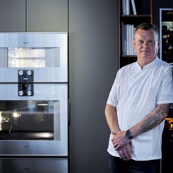 Portrait of chef Julian Robertshaw next to Gaggenau appliances