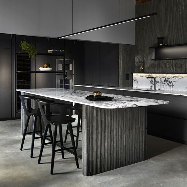 Gaggenau appliances installed in a luxury dark kitchen with island worktop