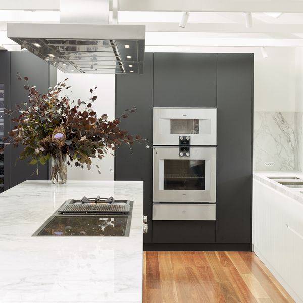 Gaggenau appliances installed in a bright luxury kitchen with island worktop, designed with Tony Tan