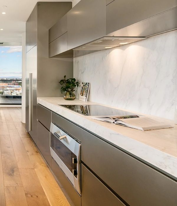 Gaggenau appliances installed in a bright luxury kitchen with a view out across the city