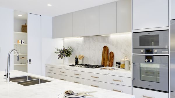 Gaggenau appliances installed in a bright luxury kitchen with marble island worktop