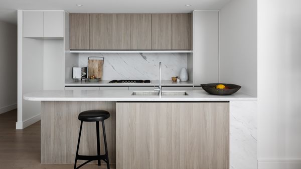 View of a bright luxury kitchen across the island worktop with a Gaggenau gas hob installed