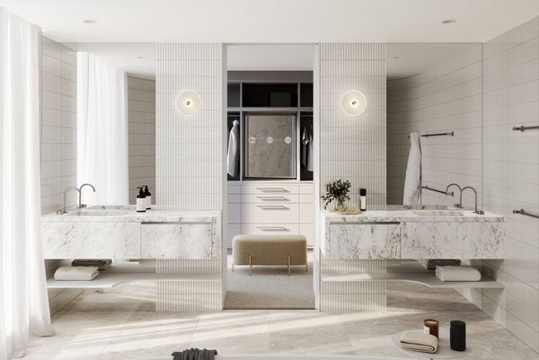 Luxury bathroom finished in light stone materials with dressing area