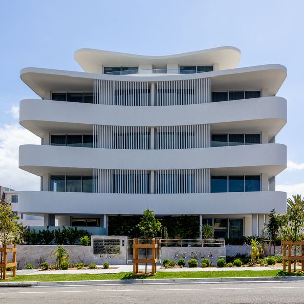 External view of Acqua’s beach apartments showing the curved balconies