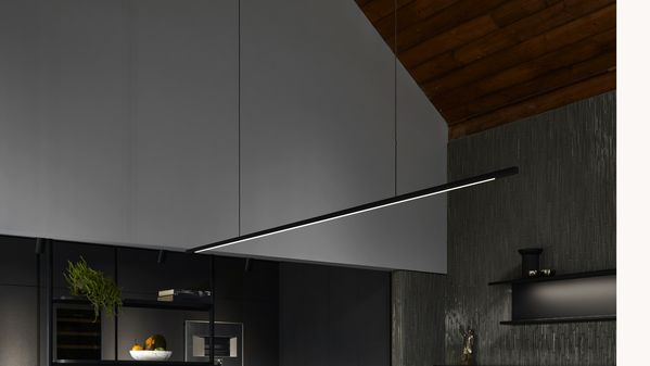 View looking up at the ceiling and a modern light fitting in a luxury dark kitchen