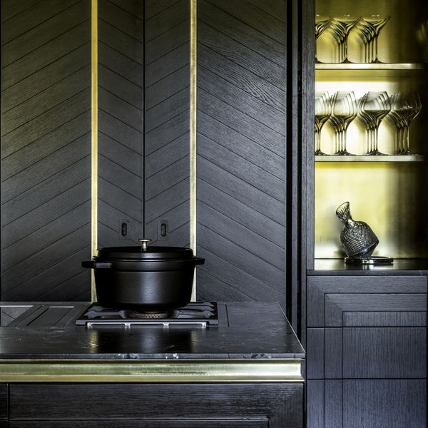Close-up of Gaggenau appliances installed in a dark luxury kitchen island worktop