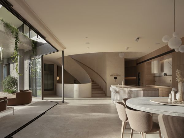 Internal view of a curved staircase and arched ceilings of luxury mediterranean style property