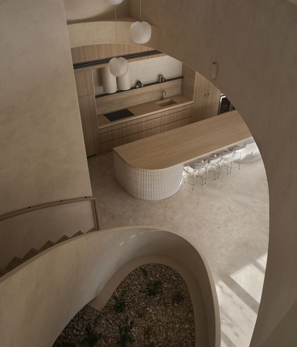 Internal view into a luxury kitchen area from a curved staircase