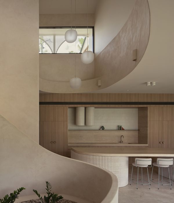 Internal view of a curved staircase and ceilings in a luxury mediterranean style property